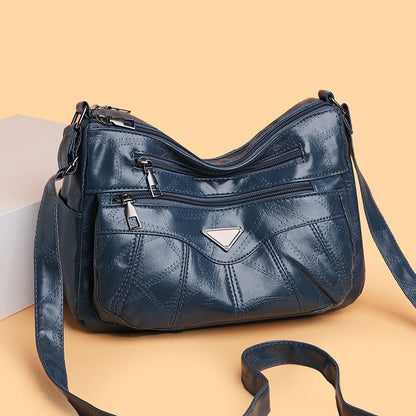 Bolso bandolera con textura de piel